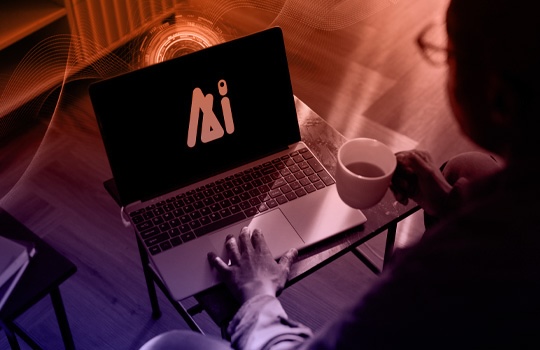 A person drinks coffee while working on a laptop.