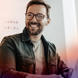 Man on his computer smiling
